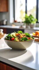 A vibrant salad in a bowl sits on a kitchen counter, bathed in sunlight
