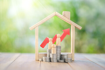 Stacks of coins, symbolizing financial growth and wealth, with a arrow pointing upward. Wooden human figures stand beside the coins, representing family and generational wealth development.