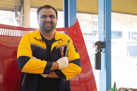 Small business garage mechanics in small business garage grips tools with safety glove, close-up wrench fix  preparation, workshop focus, professional readiness in automotive repair work by technician