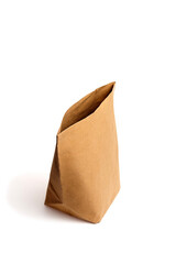 Brown paper bag stands upright against a white background, showcasing its texture and shape, ideal...
