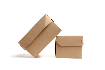 Two brown cardboard boxes, one larger and one smaller, positioned at an angle, showcasing...