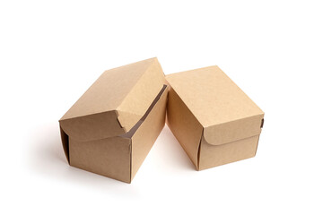 Two brown kraft paper boxes with flaps, positioned at an angle, showcasing eco-friendly packaging...