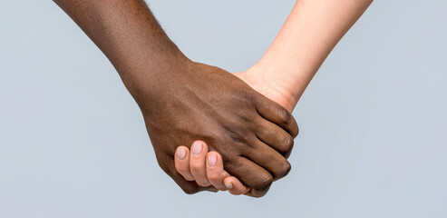 No racism. Black and white human hands in a modern handshake to show each other friendship and respect. Black and white couple. Handshake, concept. Hands black and white