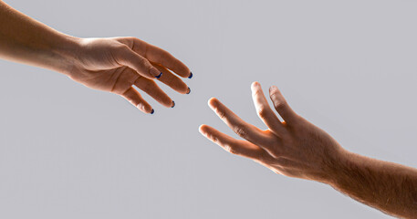 Concept for salvation, rescue, friendship, guidance, help, helping. Helping hand gesture composition isolated over gray background. Closeup two hands reaching to each other