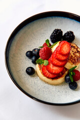 Delicious Pancakes Topped with Fresh Berries, Showcasing a Mouthwatering Blend of Strawberries, Raspberries, Blueberries, and Blackberries for a Flavorful Breakfast