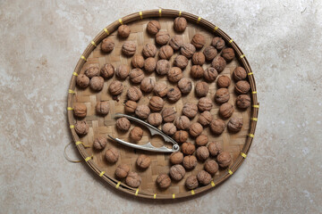 Whole and cracked walnuts and nutcracker