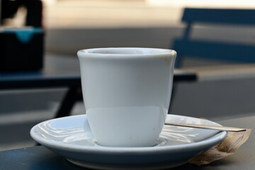 White espresso cup on a cafe table in Italy