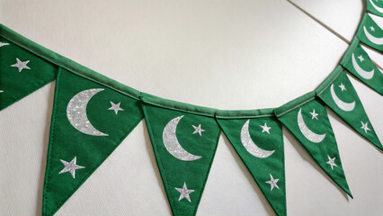 Celebrate Pakistan Independence Day with festive green bunting featuring sparkling crescent moon and stars for a vibrant national holiday display