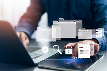 Digital document management and workflow system concept with businessman using laptop and tablet to access secure data, organize files, and streamline business processes.