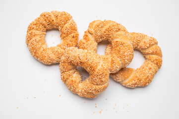 Simit or gevrek, round bagel with sesame seeds on white background top view. Traditional Turkish pastry, Istanbul street food. Delicious fresh homemade pastry, bakery product. Bagel mockup