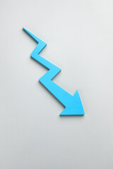 A light blue downward zigzag arrow on a light gray background, symbolizing a decline in business, finance, or market trends.