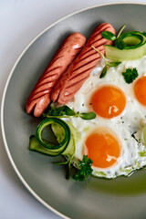 A Delicious Plate of Breakfast Featuring Eggs, Sausages, and Fresh Herbs Surrounded by Garnishes for an Inviting Morning Meal