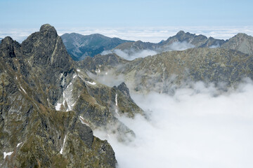 Fototapeta premium Clouds in the mountain valley, beautiful weather for climbing. 