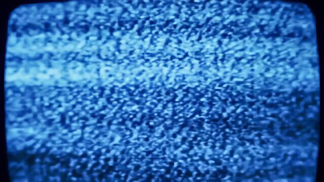 Abstract glitching blue static noise flickering across old television screens, concept for retro technology effects, vintage broadcast distortions and digital decay visuals