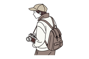 Young person with backpack and camera capturing moments in a casual outdoor setting