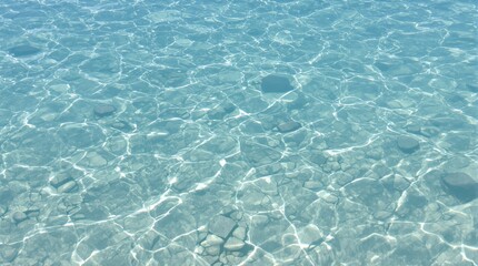 Sunlight Reflects on Clear Turquoise Water and Rocky Seabed