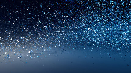 Obraz premium Abstract Blue Glittering Particles on Dark Background for Festive Celebration