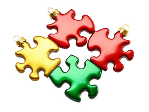 Four colorful puzzle piece christmas ornaments arranged together isolated on transparent background