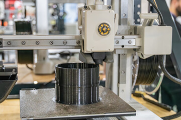 Industrial scene focusing on a robotic arm, engaged in manufacturing tasks The arm holds a ridged metallic object possibly steel or aluminum Other machinery like conveyor systems and storage unit