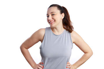 Happy woman smiling confidently in athletic sport outfit on white background