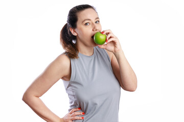 Young woman eating green apple