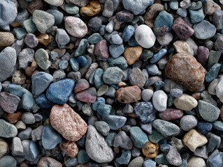 Close-up top view of a gravel texture, with various sizes of pebbles blue, red, gray, brown in shades of multiple colors, filling the frame Natural background or design element for d - AI-Generated