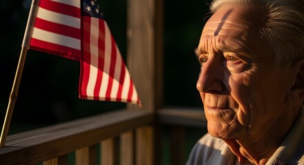 Elderly Man Looking Thoughtfully at American Flag on Porch During Sunset
