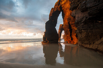 Reflections at sunset at praia das catedrais, galicia, espana