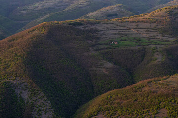 A small country house in the mountains. A beautiful photo of a mountain landscape. Photo taken from above.
