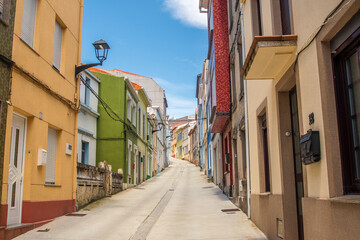 Colorful architecture in the main street of Cariño, a small town of Galicia, Spain.