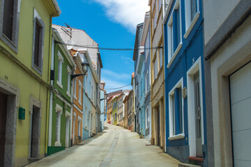 Fototapeta premium Beautiful and characteristic street with colorful houses in Cariño, Galicia, Espana, in a sunny day