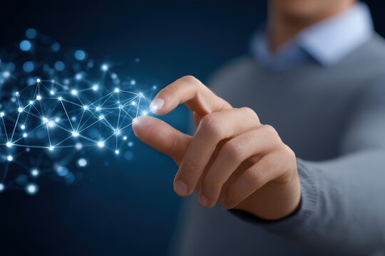 Man manipulating luminous data network with his hand in front of a dark blue background