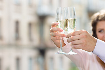 Closeup of hand holding glasses of champagne.
