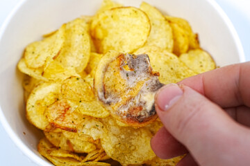rotten potato chips. potato chips with spices in a bowl. 