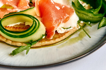 A Fresh Culinary Delight Featuring Creamy Cheese, Luxurious Salmon, and Crisp Vegetables on a Savory Flatbread Base