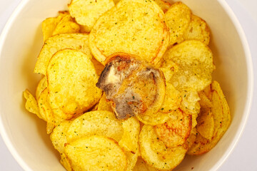 rotten potato chips. potato chips with spices in a bowl. 