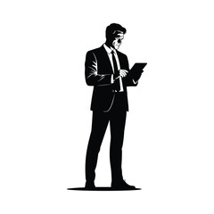 Silhouette of a businessman in a suit using a tablet computer