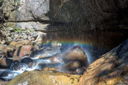 Falling water gives streaky rainbow in Rainbow Gorge
