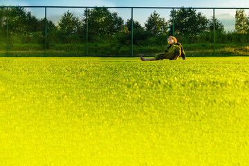 The child goes in for sports at the stadium. The boy training before playing football. banner with copy space