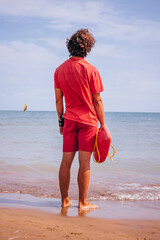 Lifeguard Standing on the Beach Watching the Sea.