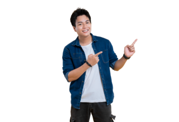 A young man in denim shirt with a pointing pose. He is smiling.