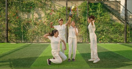 Indian young adult gen z sports woman lady group team wear white dress win cricket match trophy outdoor happy female player jumping clap hand hugging having fun joy enjoy outside play ground day time - Powered by Adobe