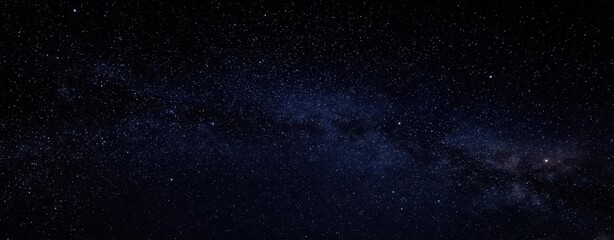 Obraz premium The breathtaking view of the Milky Way in a star-filled night sky.