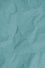 Crumpled teal paper with wrinkled and textured background