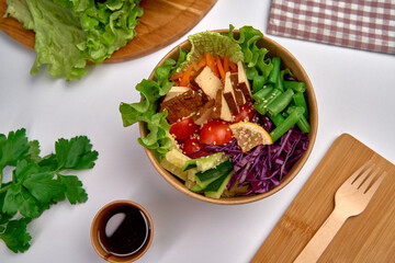 A Vibrant and Nutritious Salad Bowl Featuring Fresh Greens, Colorful Vegetables, Tofu, and Garnishes for a Healthy Meal Option Full of Flavor and Texture