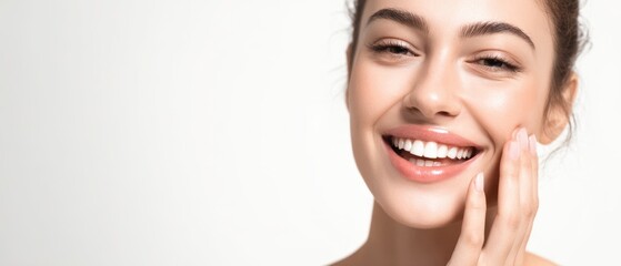 Obraz premium The radiant beauty of a young woman showcasing her joyful smile.