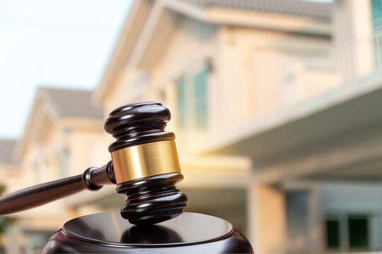 Judge gavel on background of private house, court hammer, housing estate, concept of land, construction, housing, home real estate
