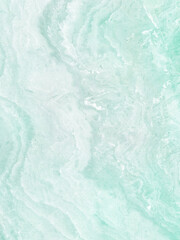 A close-up of a marble-like texture with a pale green and white color gradient. The surface has swirling patterns and a smooth appearance.