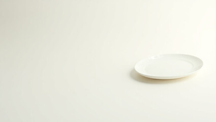 A simple white plate sits on a plain white background, isolated on white background, providing a clean and versatile surface for showcasing culinary creations