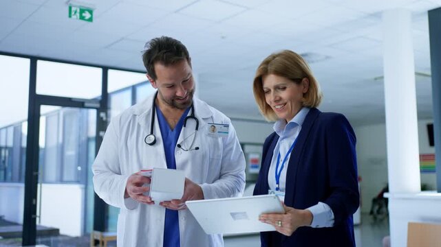 Female medical sales representative presenting medication to doctor